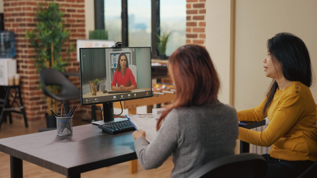 Two asian women interviewing a candidate remotely